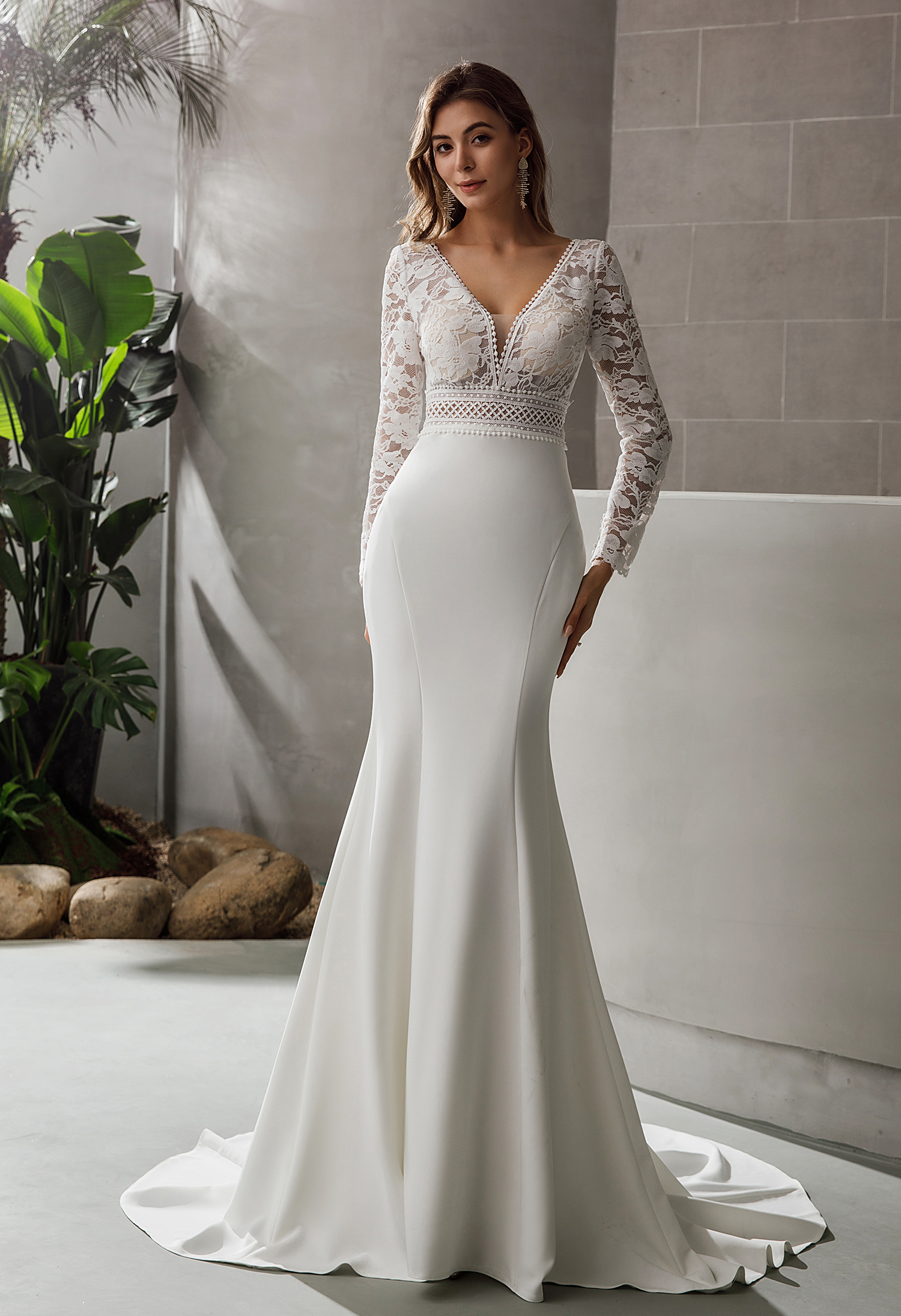 A fitted crepe gown with lace bodice and long sleeves for modern elegance. Perfect for brides who adore clean lines and 