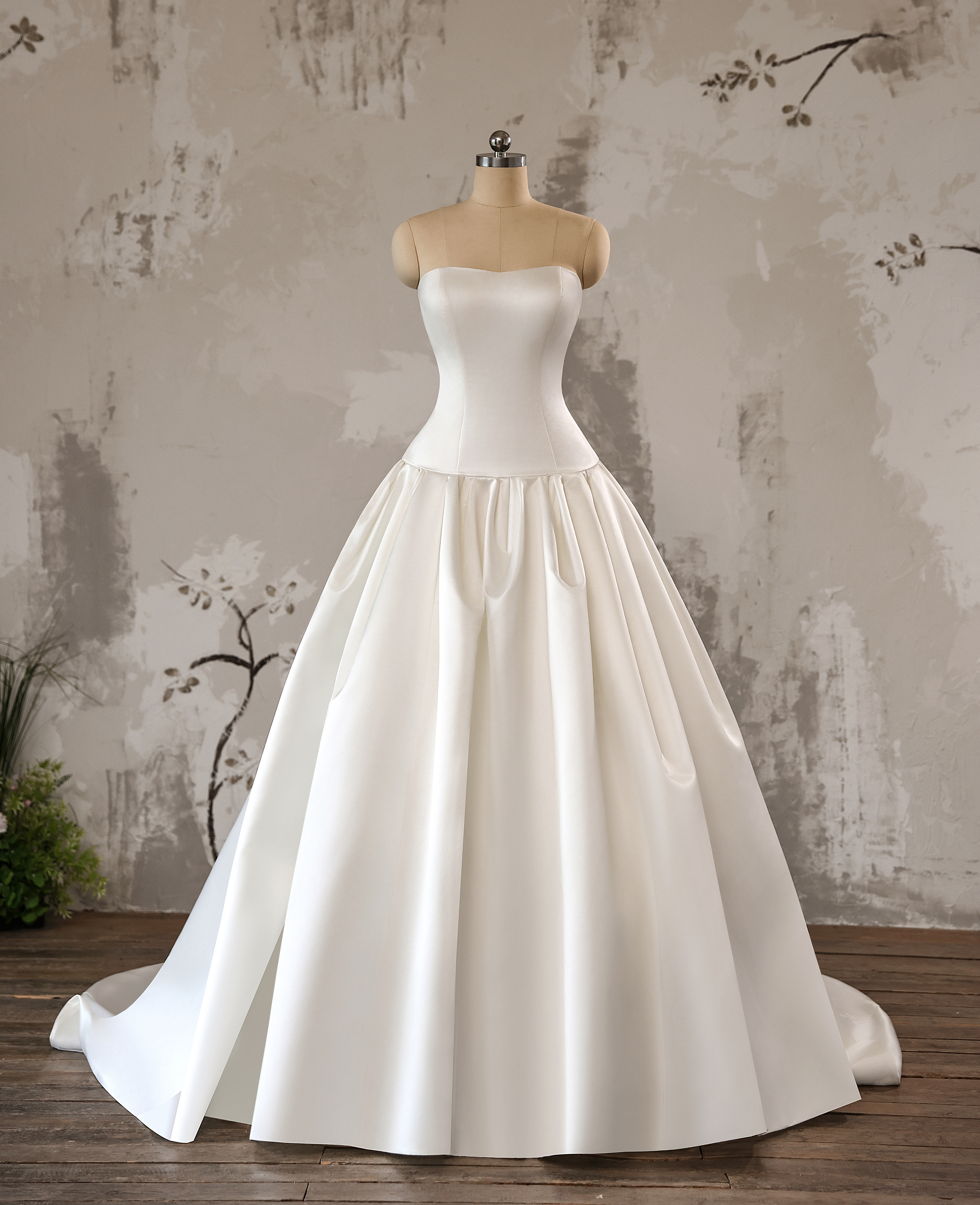 Clean lines and a full satin skirt define this timeless ball gown—perfect for minimalist brides seeking refined elegance