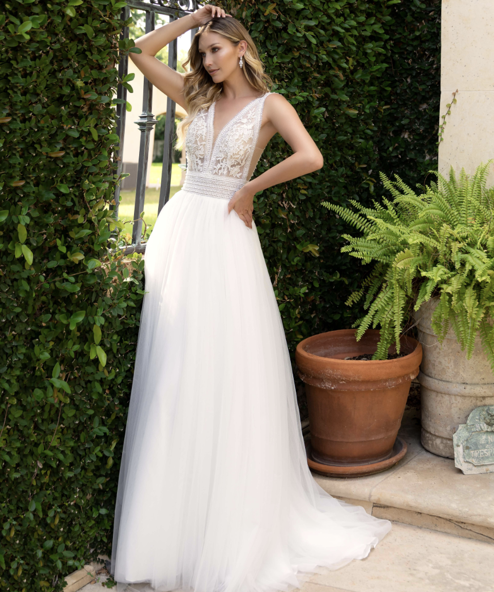 Light, airy, and effortlessly elegant — this A-line wedding gown features a plunging lace bodice, beaded waistband, and 