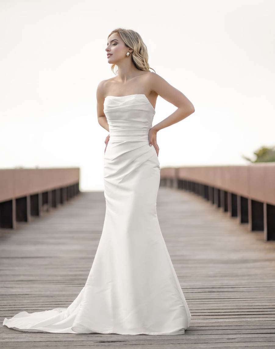 Timeless and sophisticated, this strapless satin gown features soft draping through the bodice and a sleek fit-and-flare
