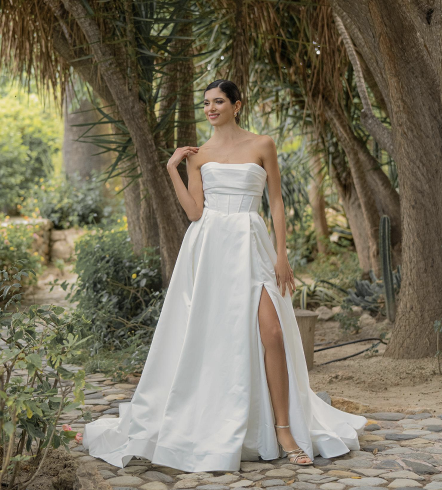 Sleek, bold, and beautifully structured — this strapless satin wedding gown features a corset-inspired bodice and a mode