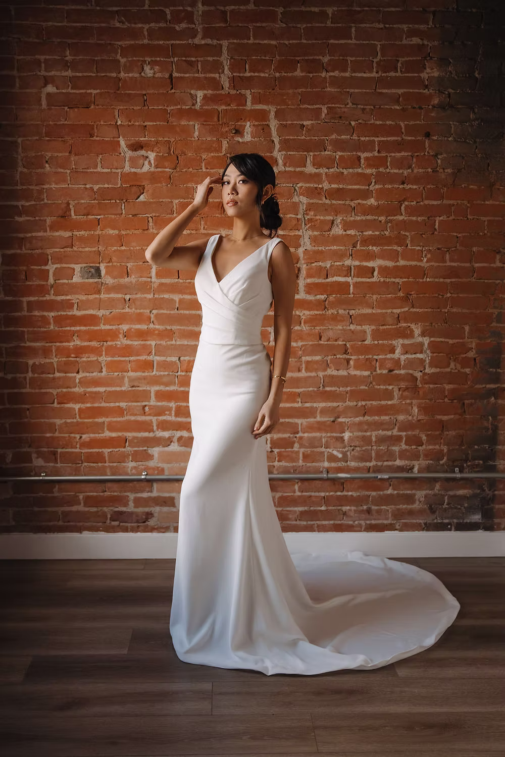 Elevate your bridal ensemble with this exquisite crepe gown, featuring delicate gathers on the upper body that add dimen