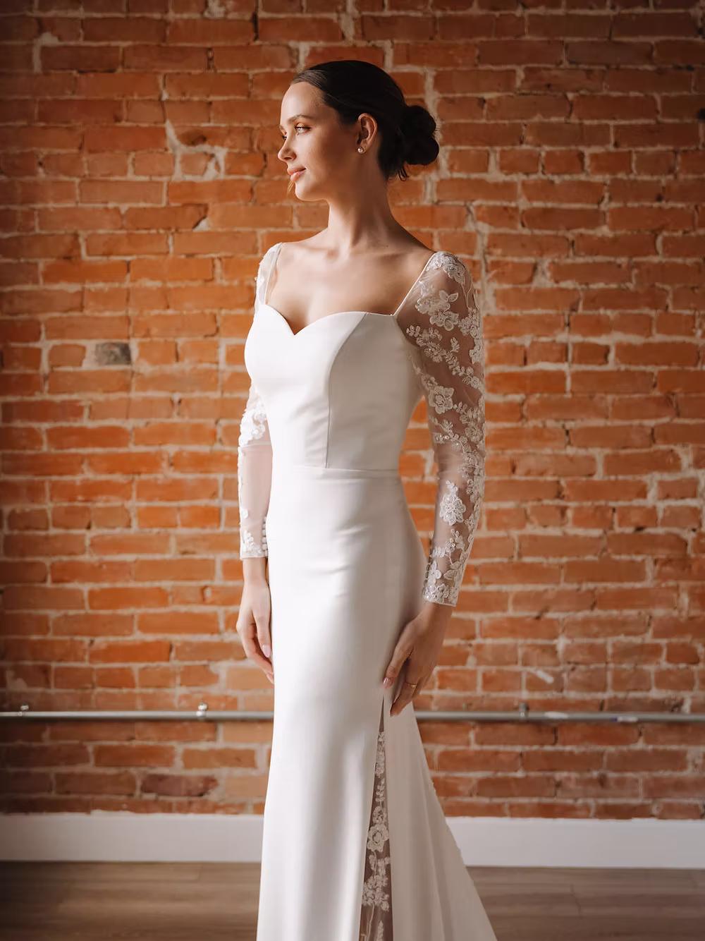 Experience the exquisite beauty of this gown, where tulle sleeves adorned with delicate appliqués perfectly complement t