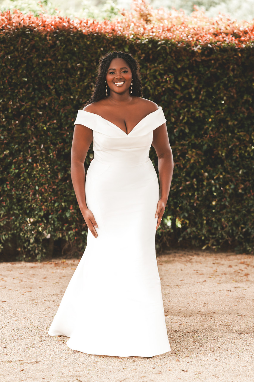 Sleek and timeless, this off-the-shoulder satin gown flatters every curve with its elegant fit-and-flare silhouette. The