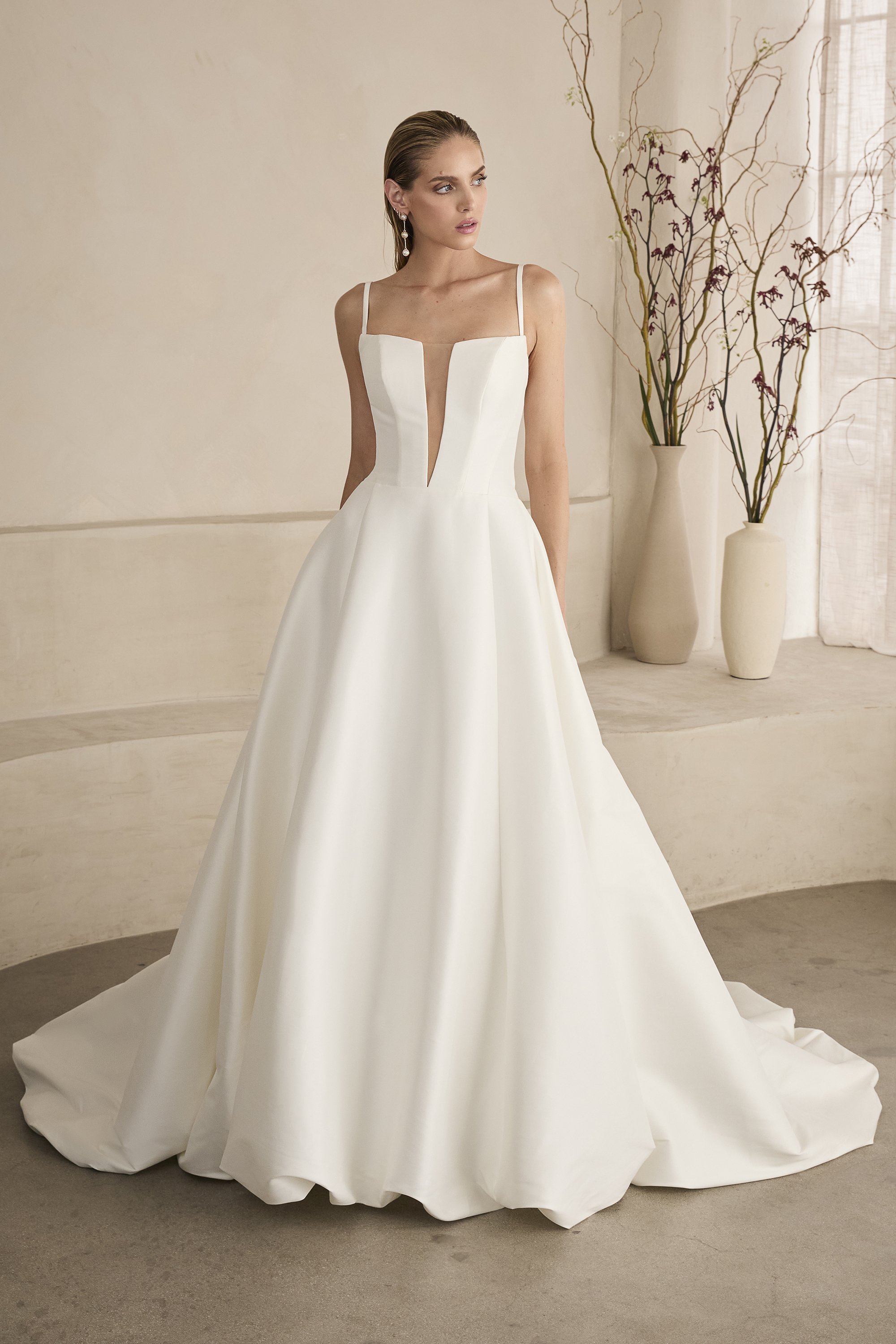 Classic meets contemporary in this stunning square-neck ball gown. With sleek straps, a deep illusion neckline, and stru