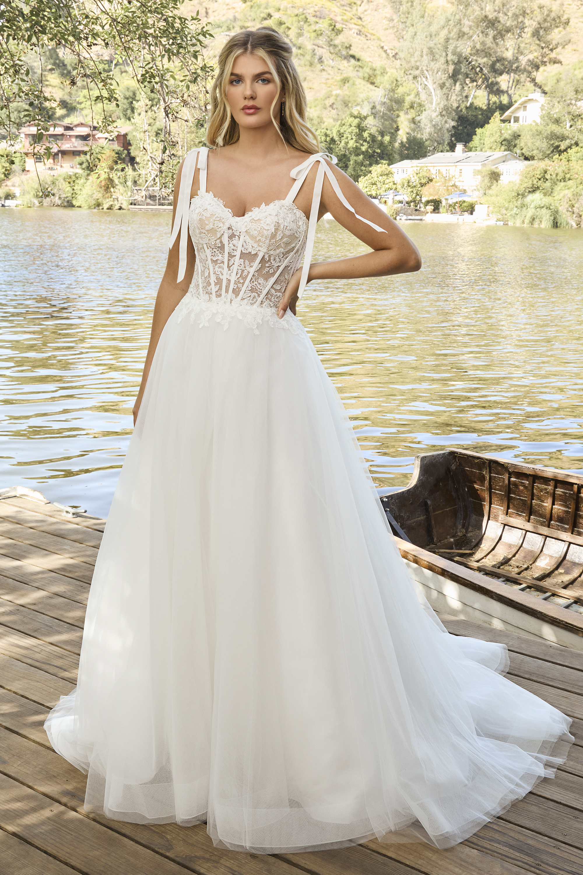 Soft, whimsical, and effortlessly romantic — this lace corset wedding gown features delicate bow-tie straps, a sheer bod