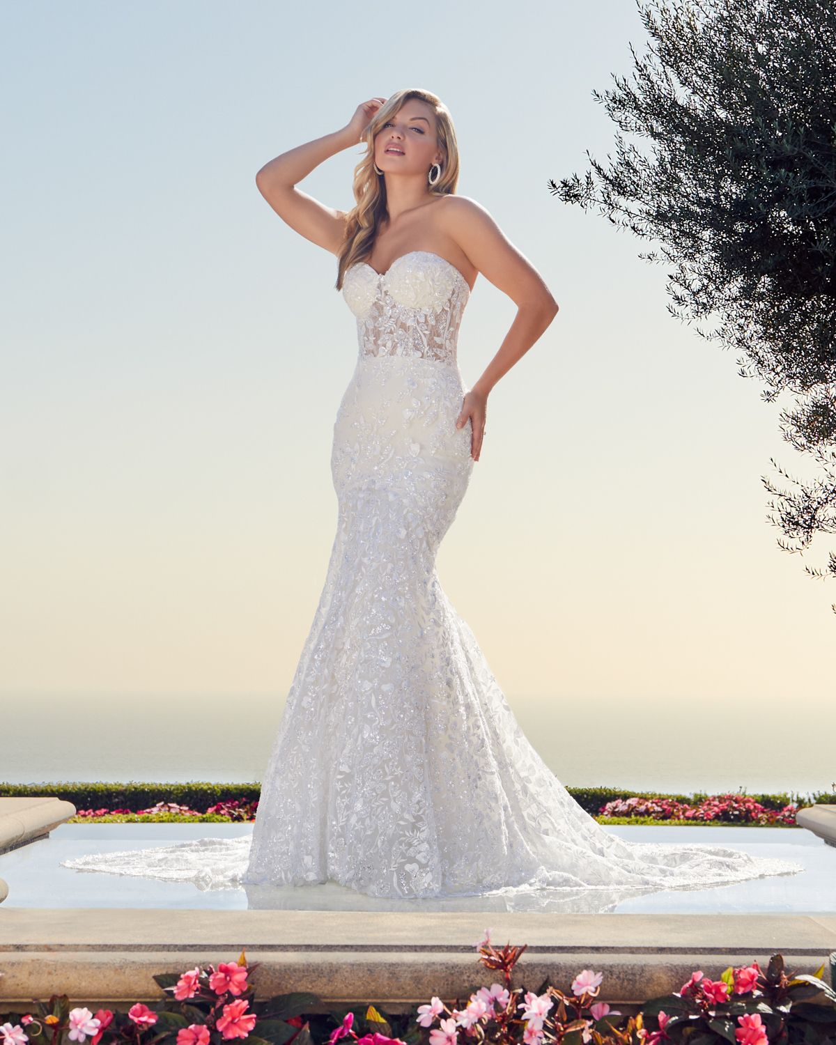 A show-stopping strapless mermaid gown that sparkles from every angle. Featuring a sheer corset bodice, intricate beaded