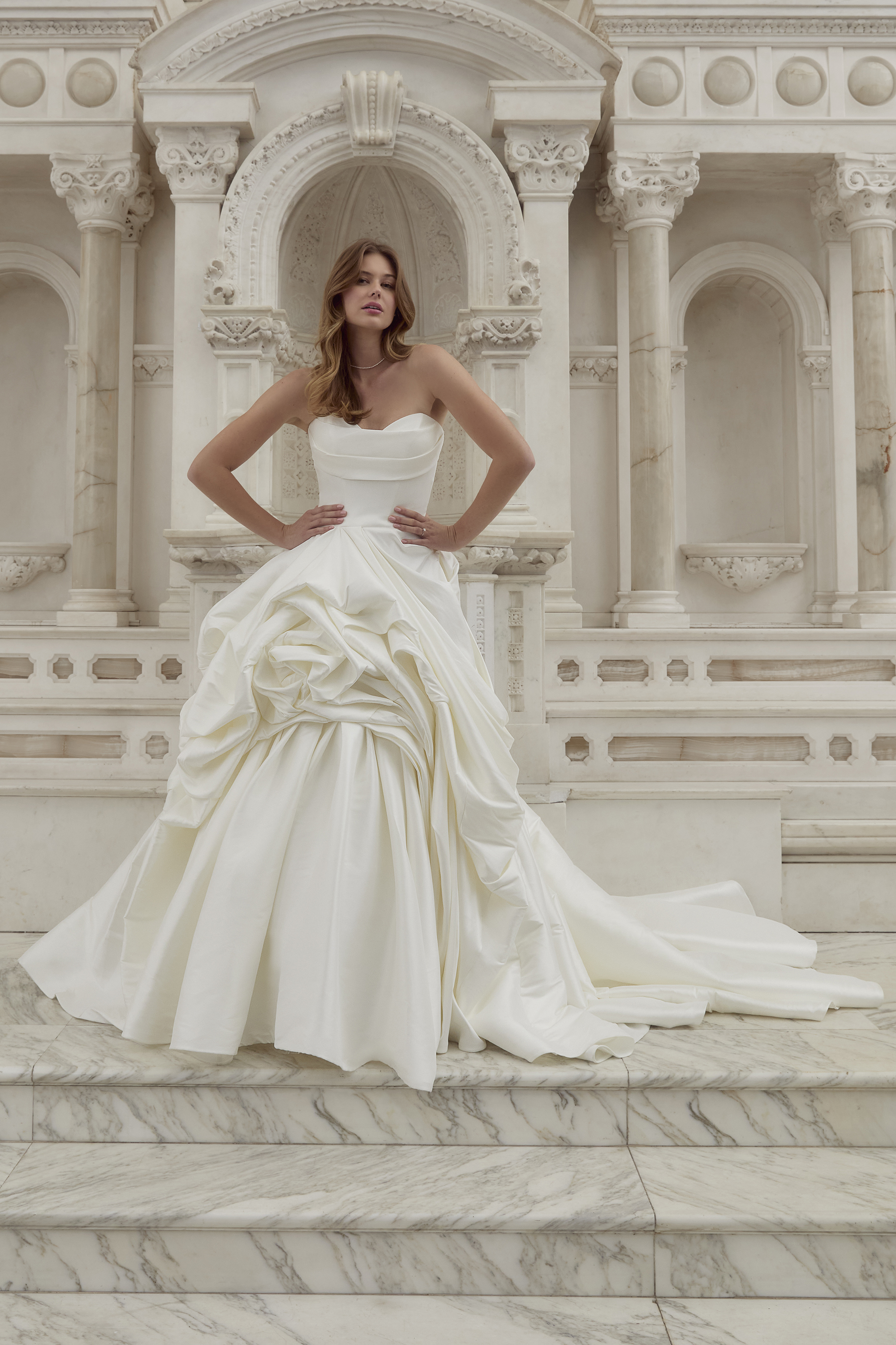Make a grand entrance in this couture-inspired ball gown featuring a strapless neckline and stunning sculpted draping. T