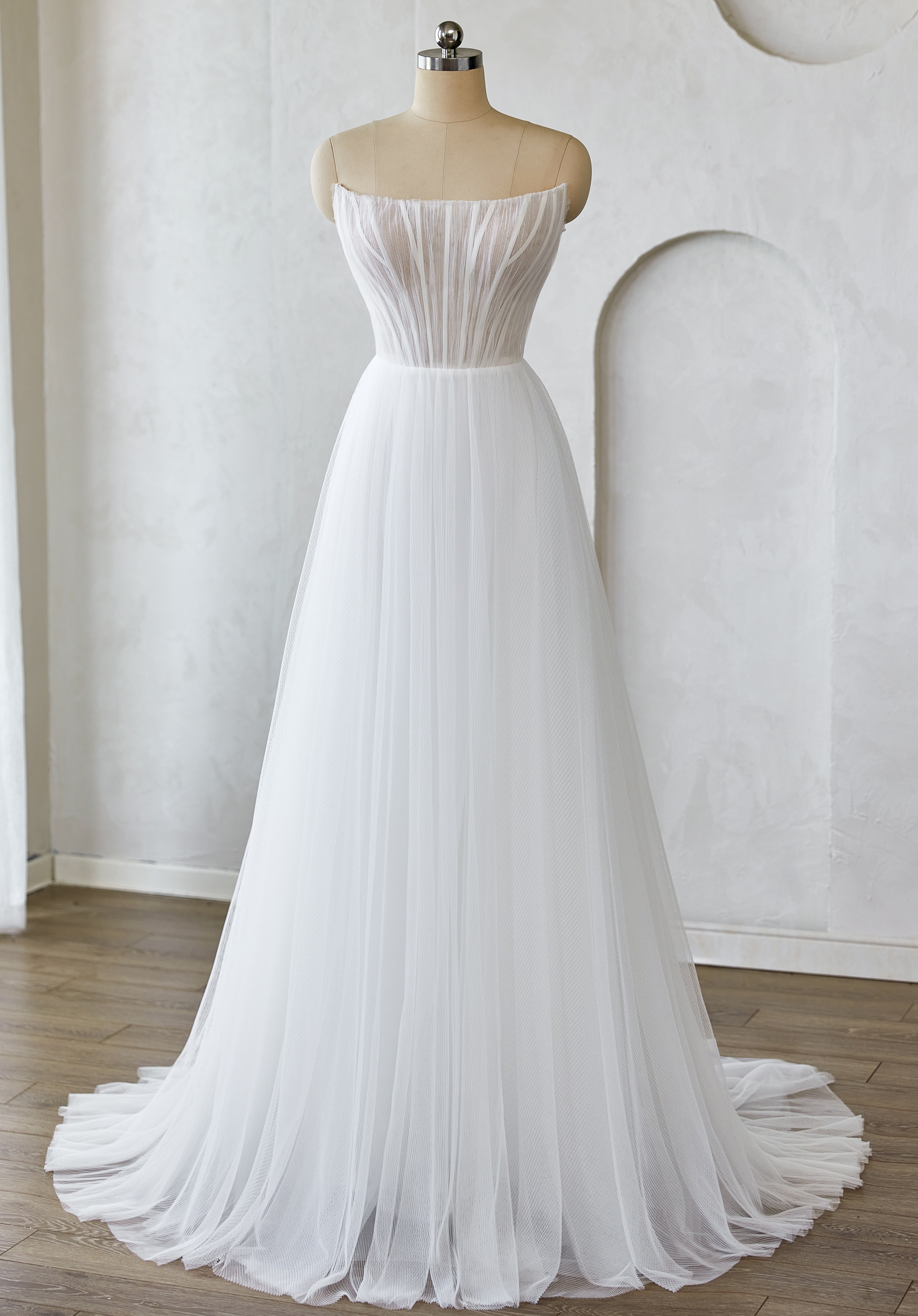 Soft tulle and a structured corset bodice float effortlessly for a dreamy, romantic look. Perfect for modern brides want