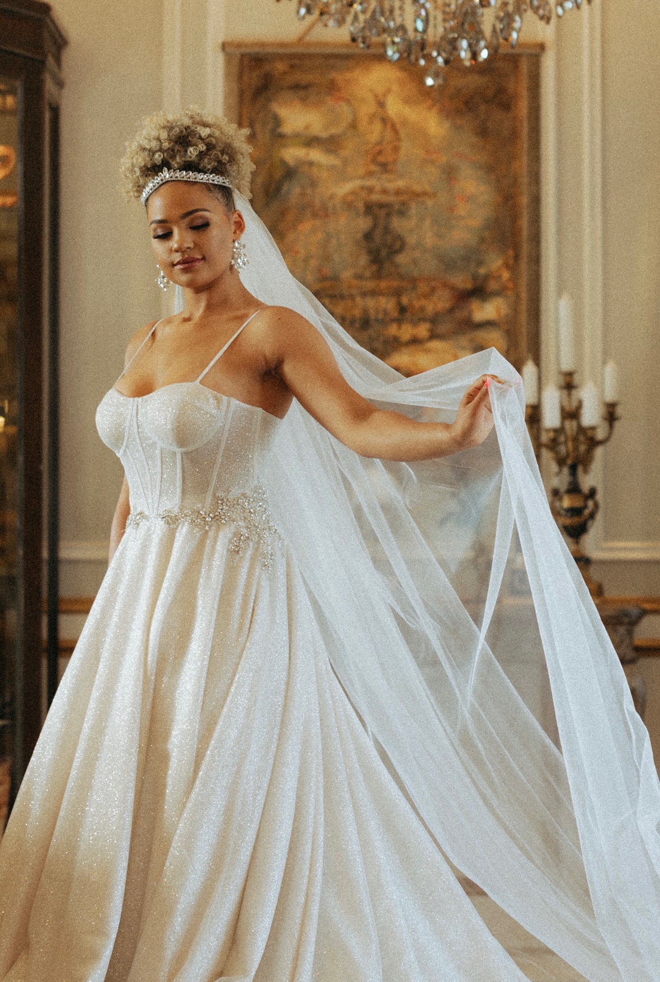 Radiate confidence in this sparkling corset ball gown featuring delicate spaghetti straps and a shimmering A-line skirt.