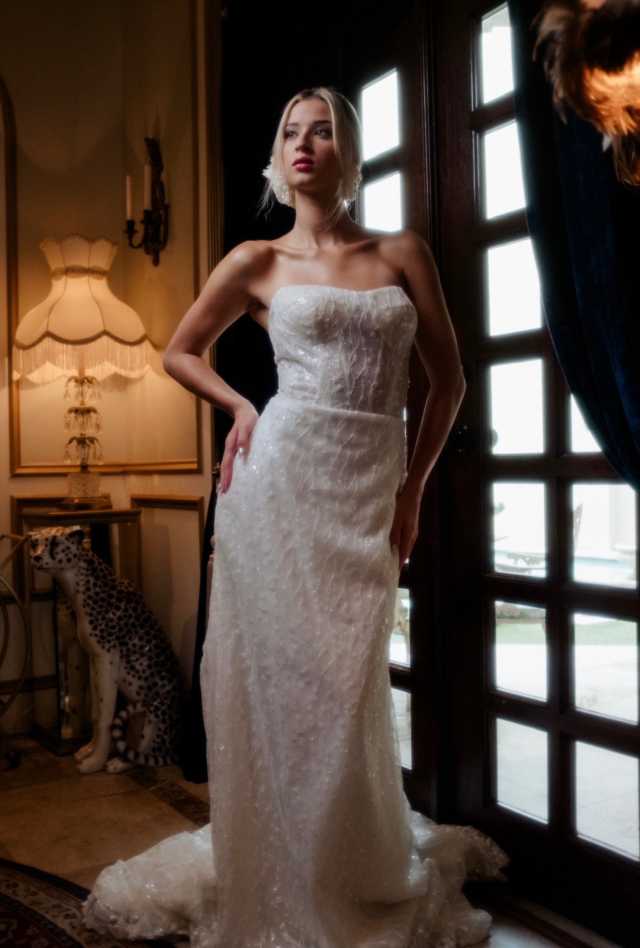 Modern elegance meets old-world glamour in this strapless pearl-detailed gown. The structured corset bodice and subtle s