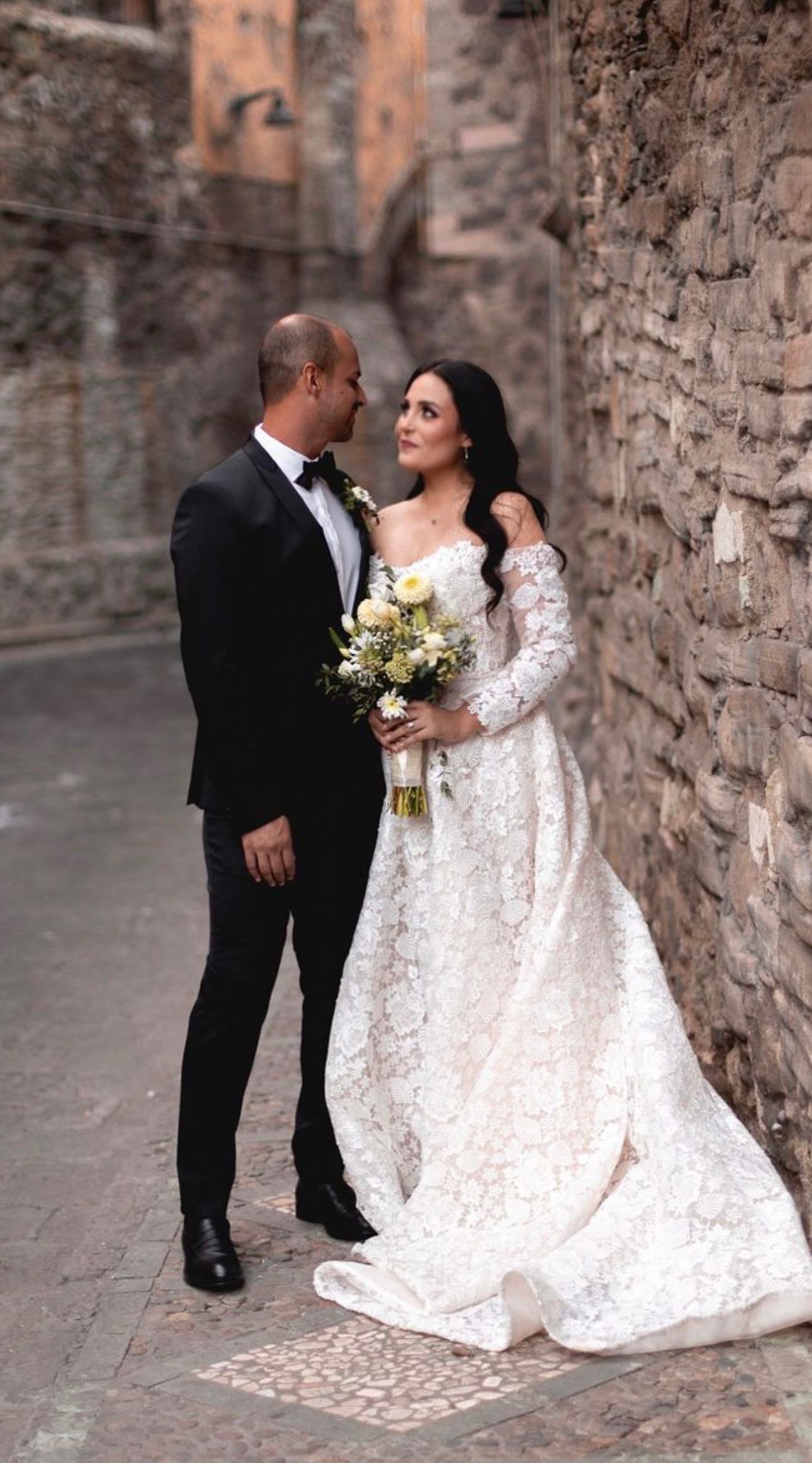Romance comes alive in this off-shoulder vintage lace gown featuring full sleeves and an elegant A-line silhouette. The 