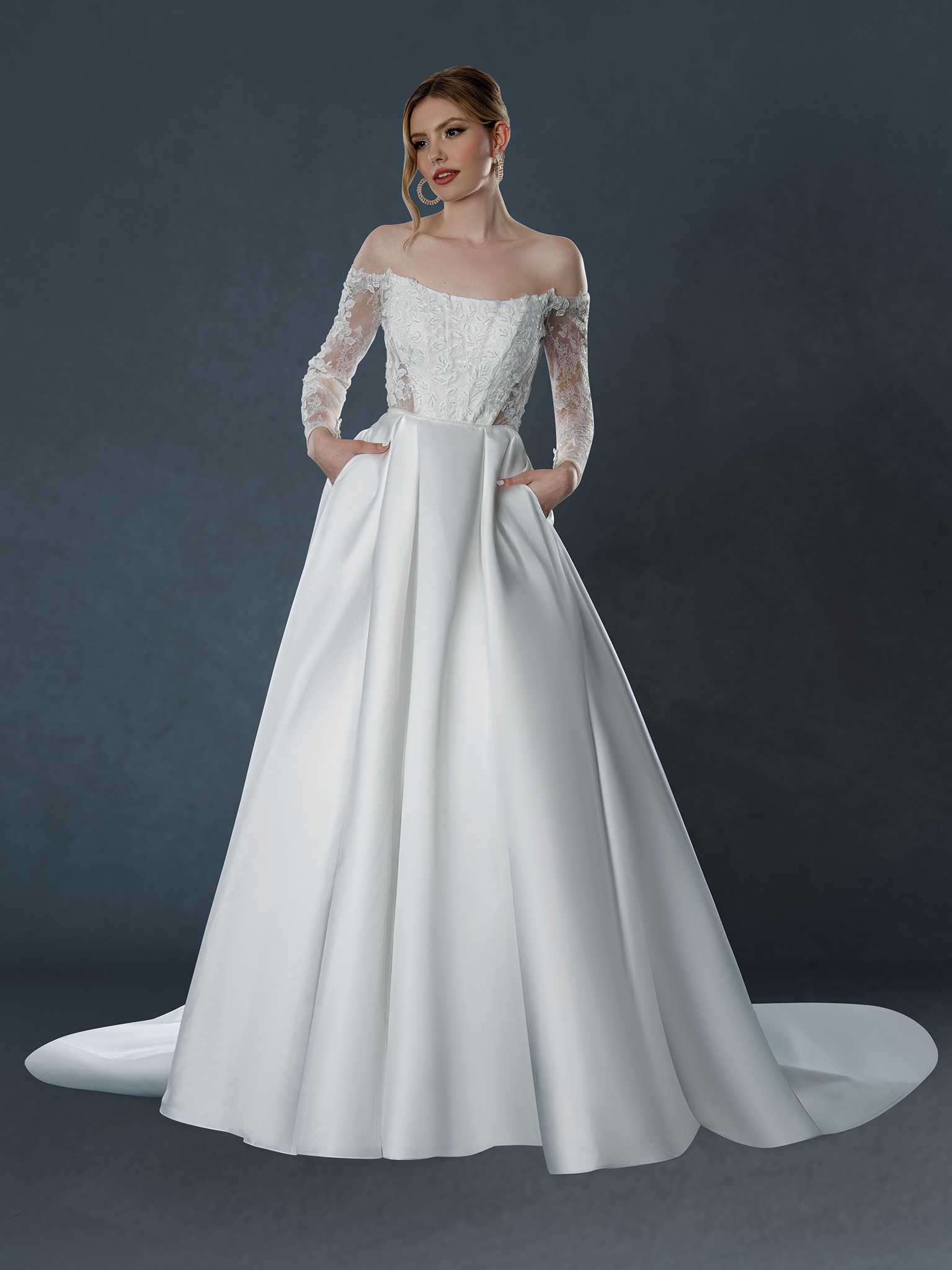 A modern royal dream. This off-the-shoulder lace ball gown features a structured satin skirt (with pockets!) and delicat