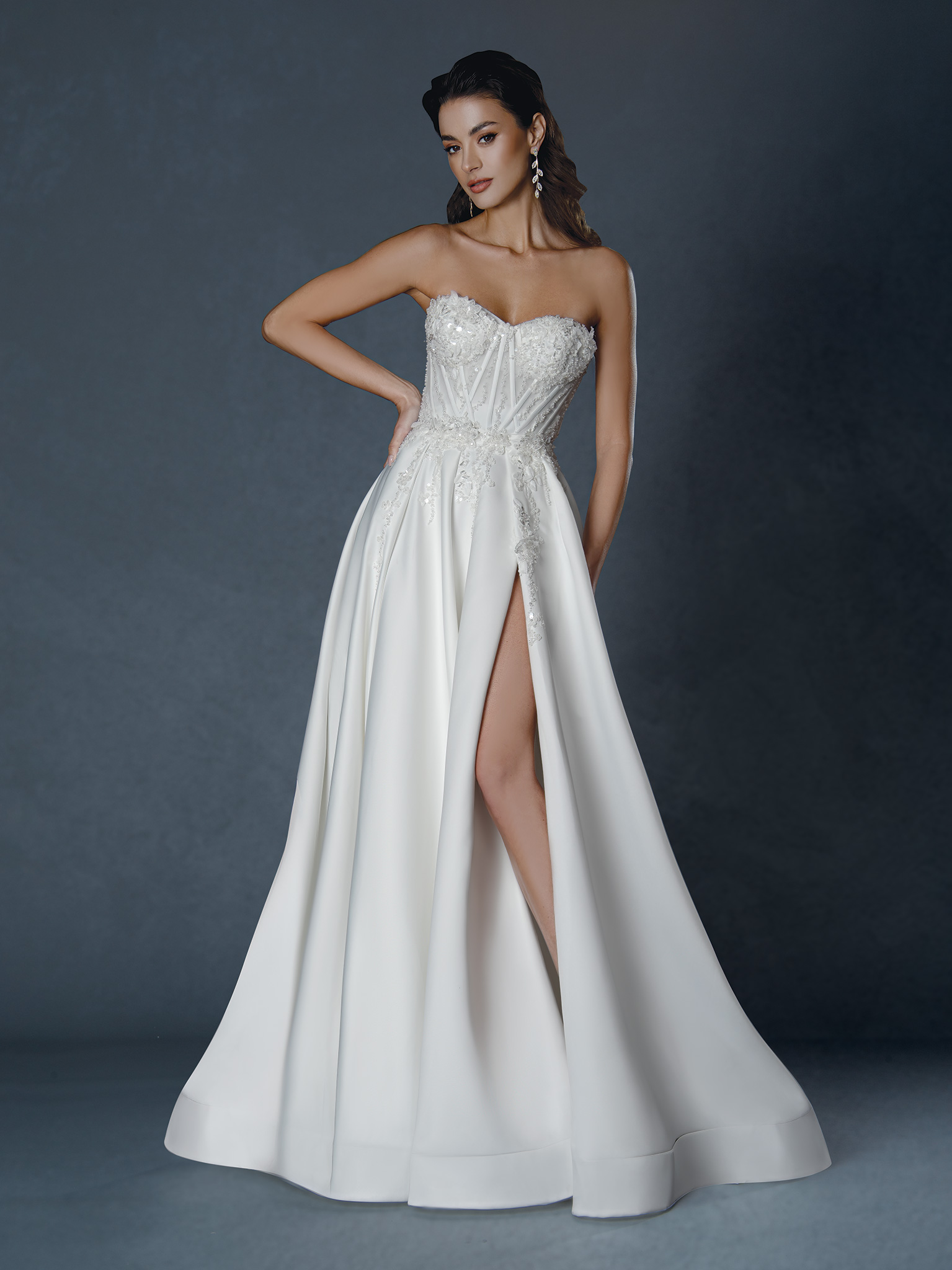 Bold, sophisticated, and effortlessly chic — this strapless satin gown features a structured corset bodice, soft pleatin