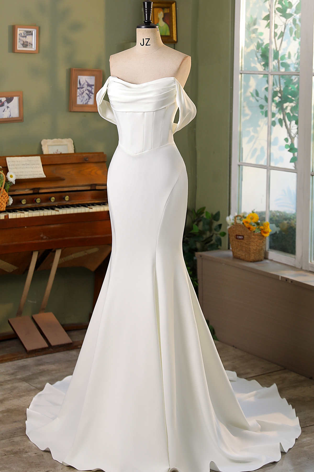 Chic and timeless, this strapless satin gown features a softly draped neckline, corset bodice, and sleek silhouette that