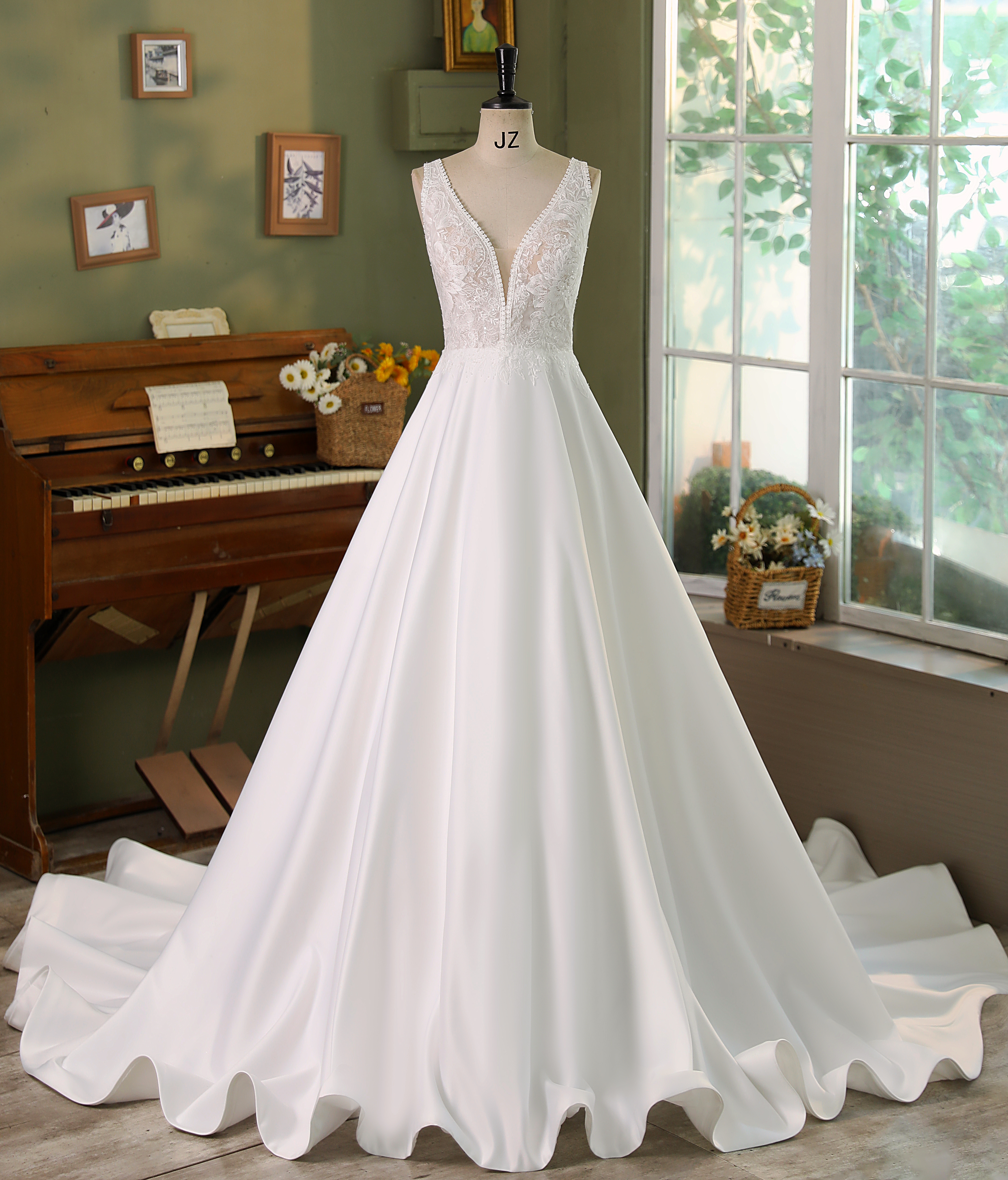 A perfect balance of modern sophistication and classic romance, this A-line wedding dress features a plunging lace bodic