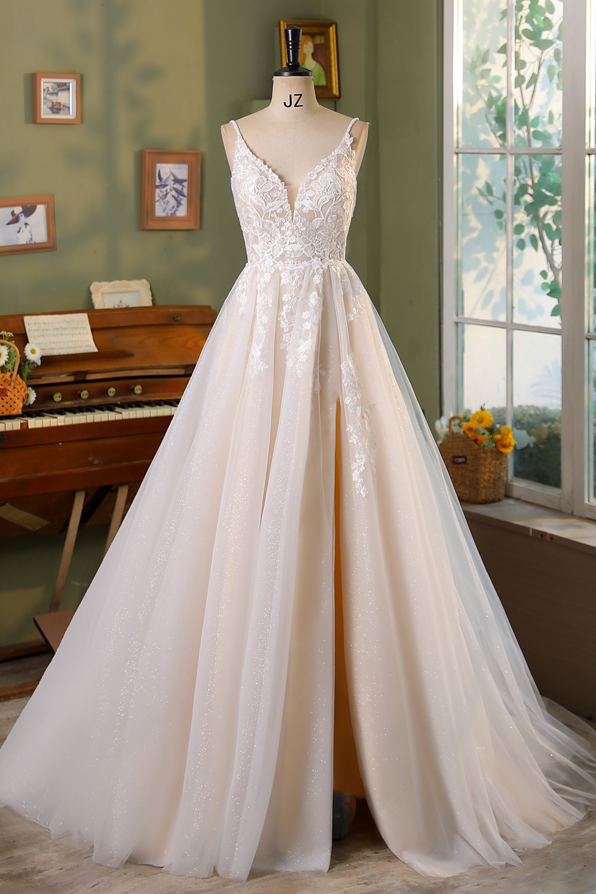 Dreamy and effortlessly romantic, this A-line gown features a shimmering tulle skirt, floral lace bodice, and subtle blu