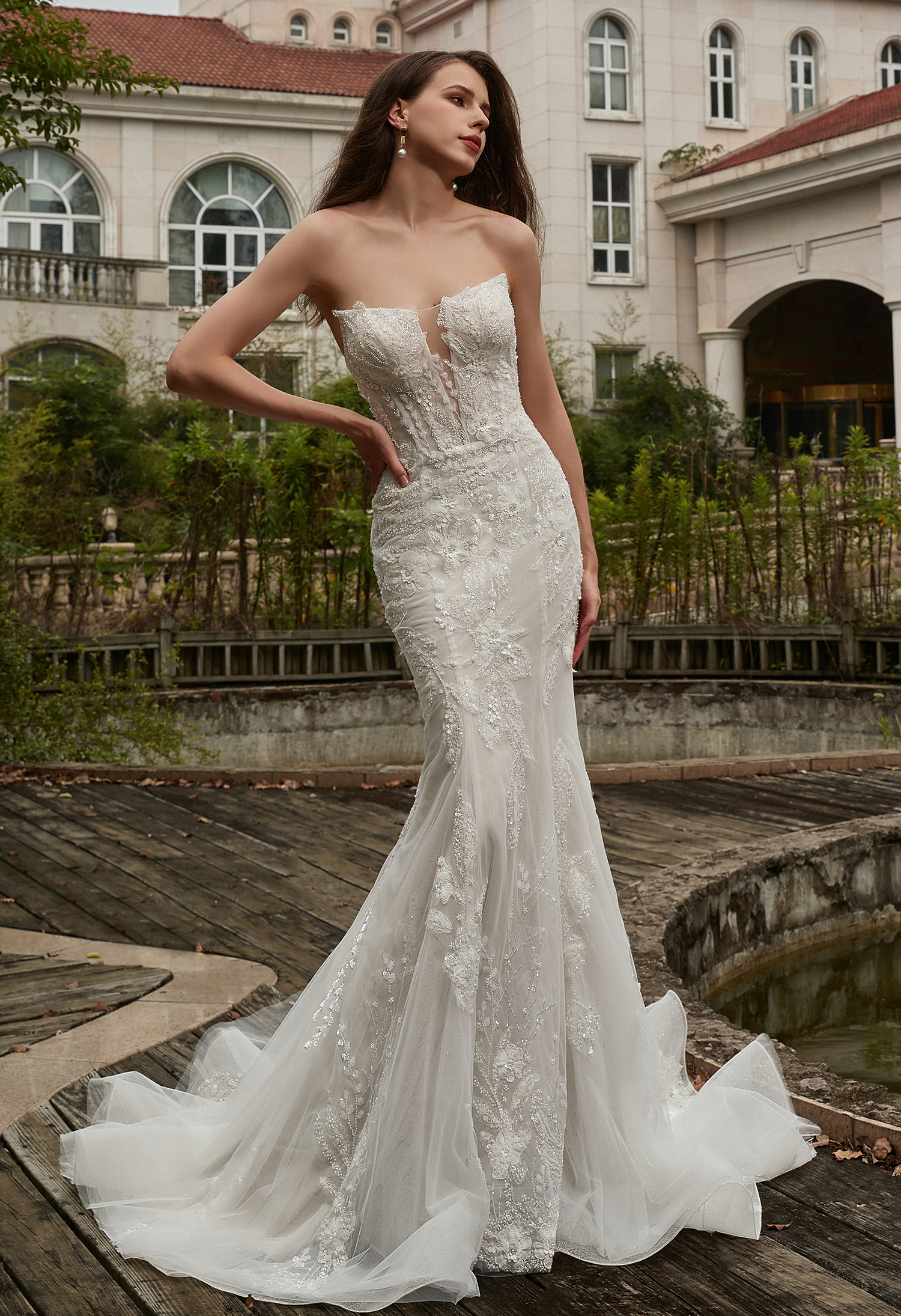 A sculpted silhouette and illusion neckline create refined glamour. Ideal for confident brides who love timeless detail.