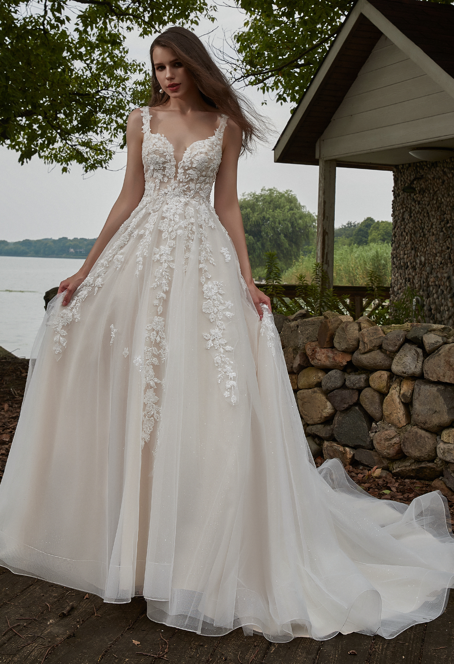 Floral Appliqués and a soft tulle skirt bring natural beauty to this airy A-line gown—perfect for Hill Country weddings.