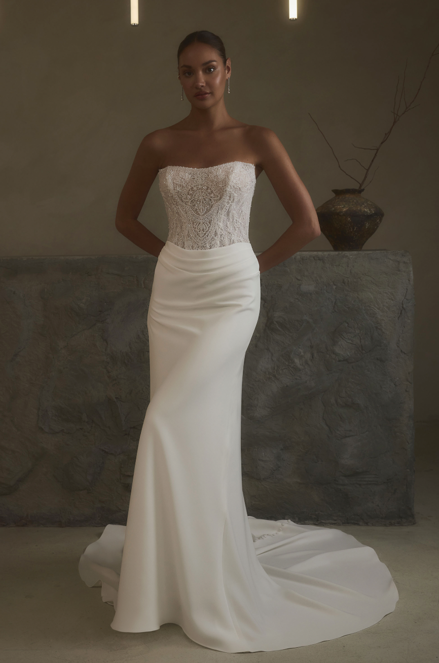 Effortless and refined, this strapless sheath gown pairs a detailed lace bodice with a smooth crepe skirt that flows bea