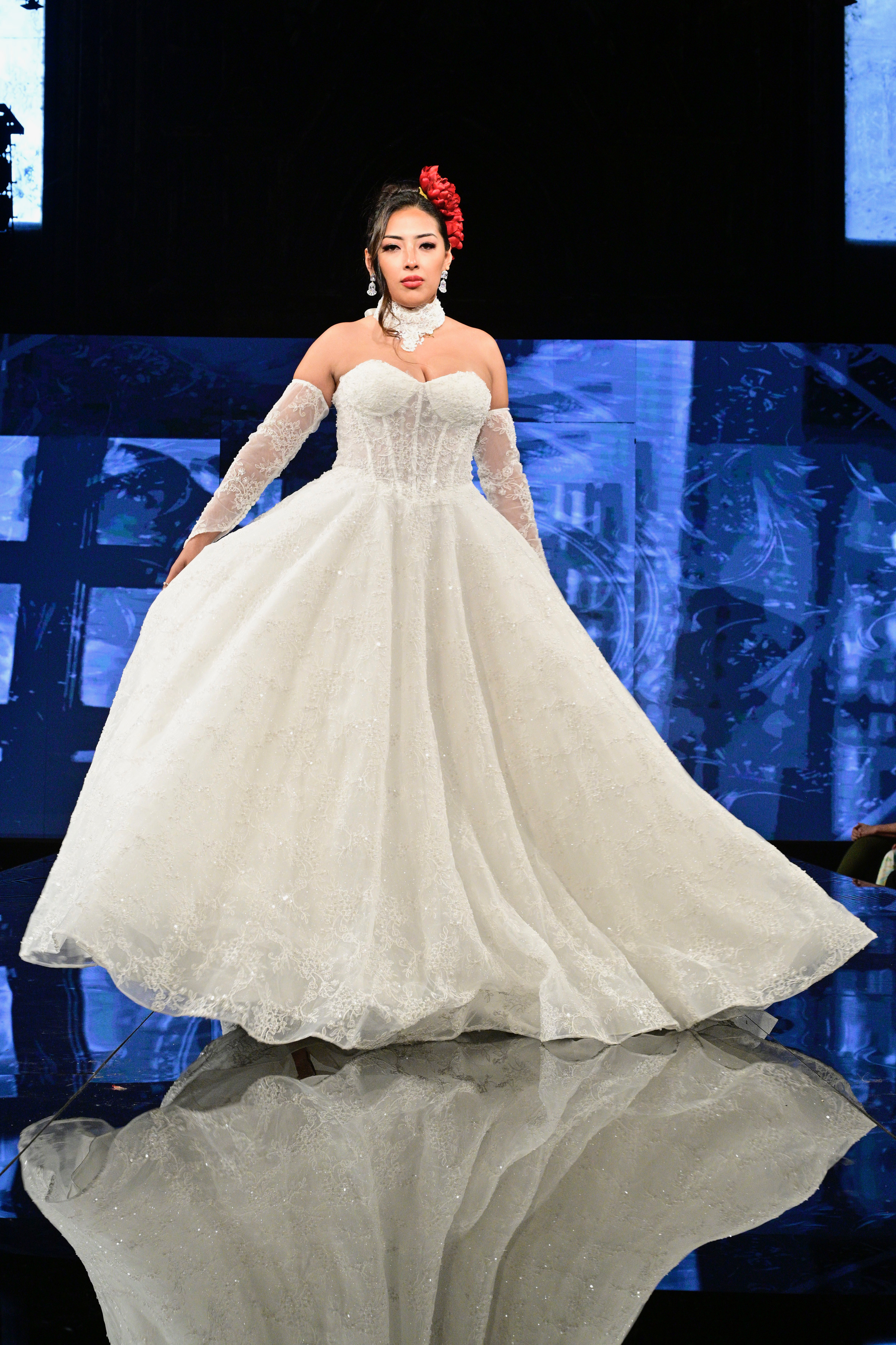 Step into royalty with this grand off-shoulder ball gown featuring a structured corset bodice, romantic lace sleeves, an