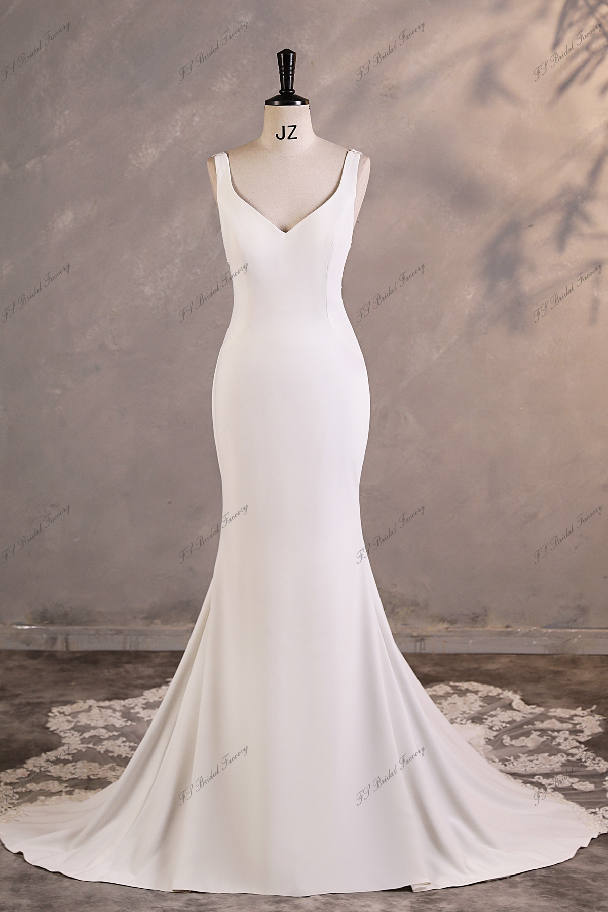 Chic and timeless, this minimalist crepe gown features a soft V neckline, sleek straps, and a gently flared skirt that g