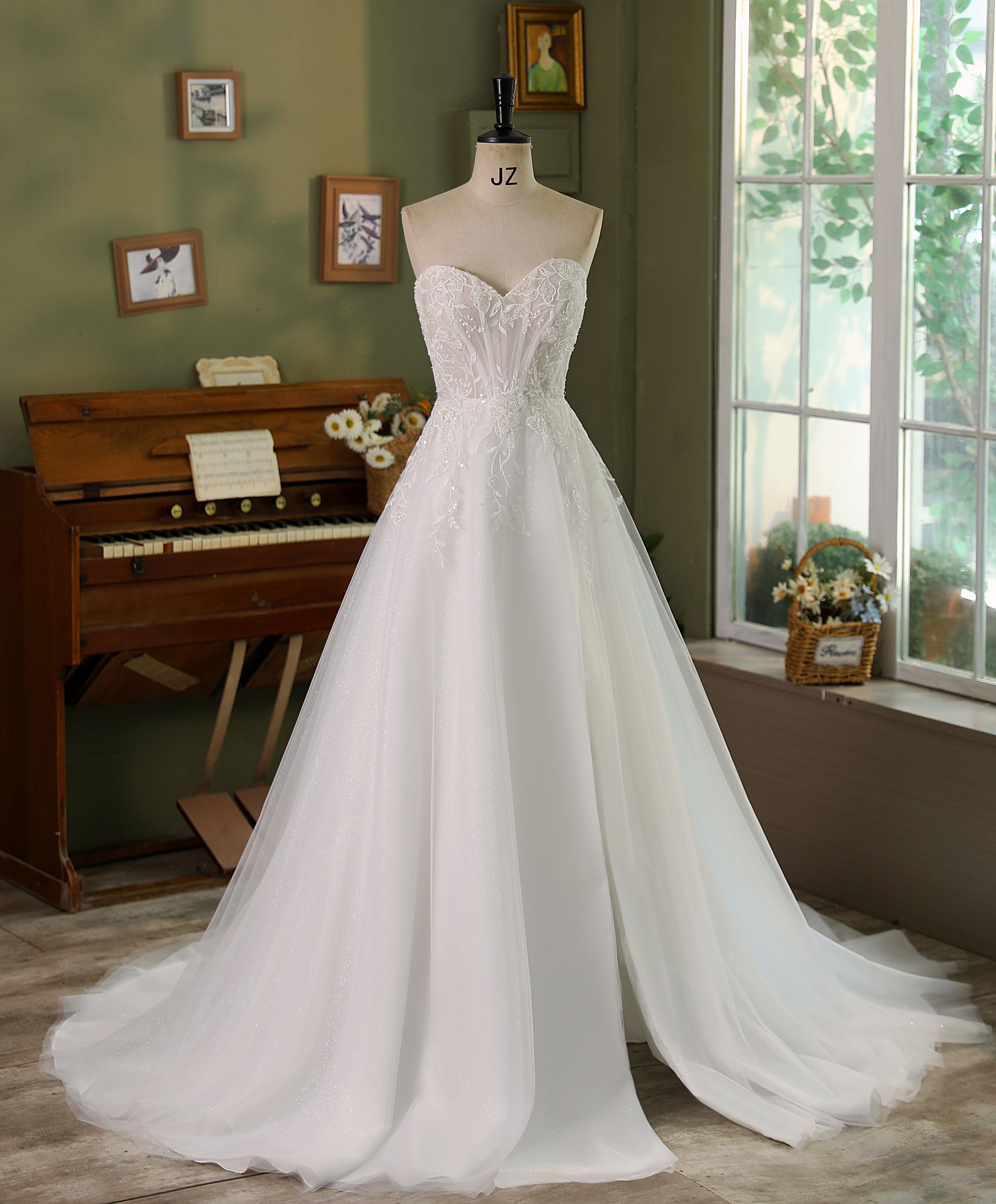 Embrace your fairytale dreams in this captivating A-line wedding dress, where delicate lace meets shimmering tulle for a