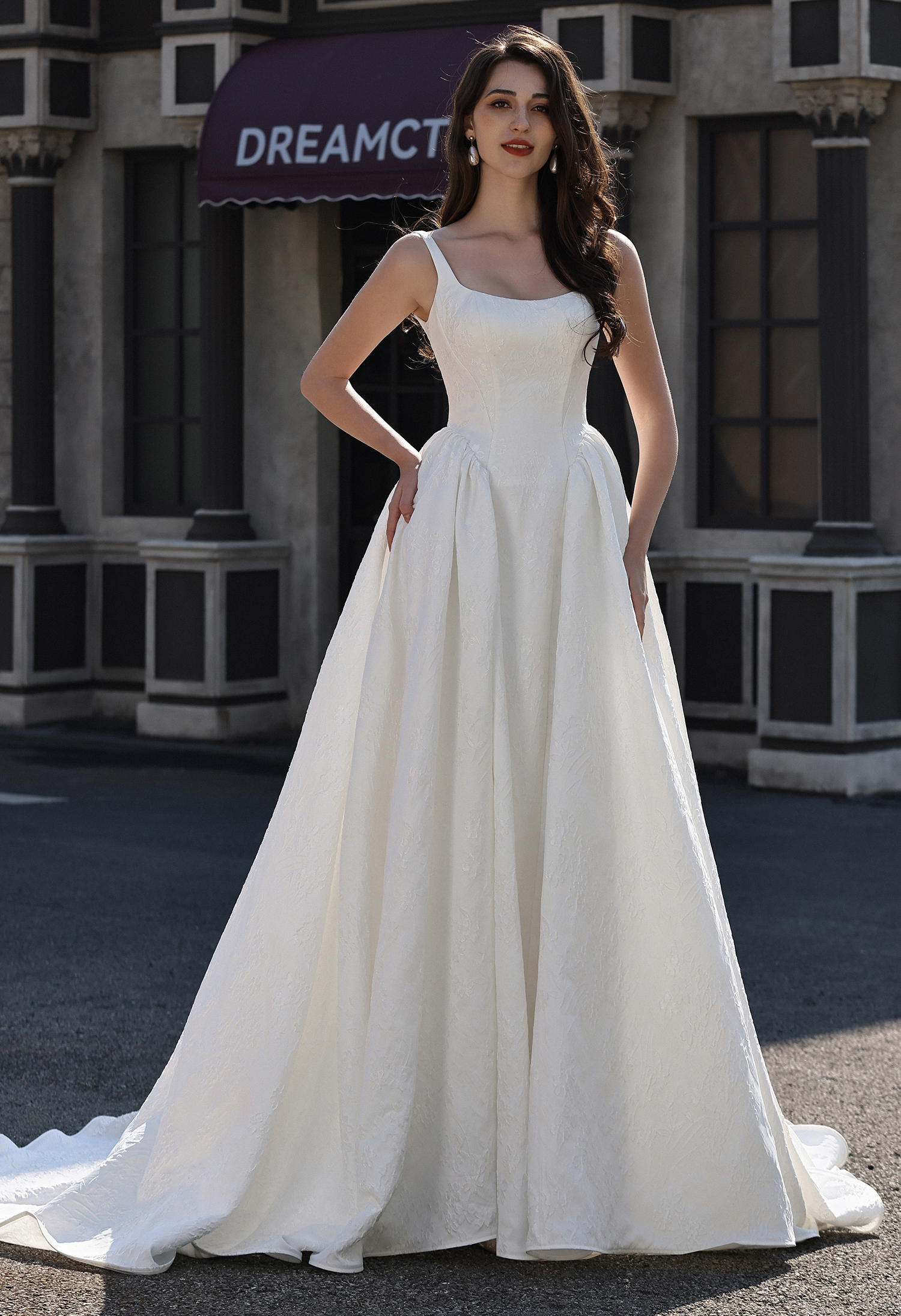 This classic square neck ball gown wedding dress features clean lines, a flattering corset bodice, and an elegant full s