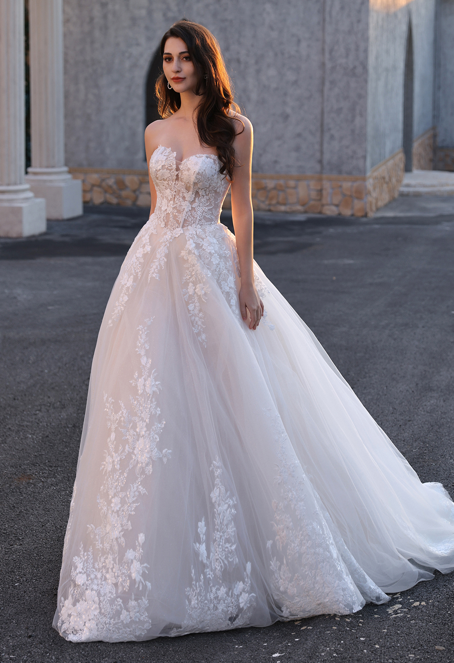 This off-the-shoulder lace ball gown wedding dress features a structured corset bodice, delicate floral lace detailing, 
