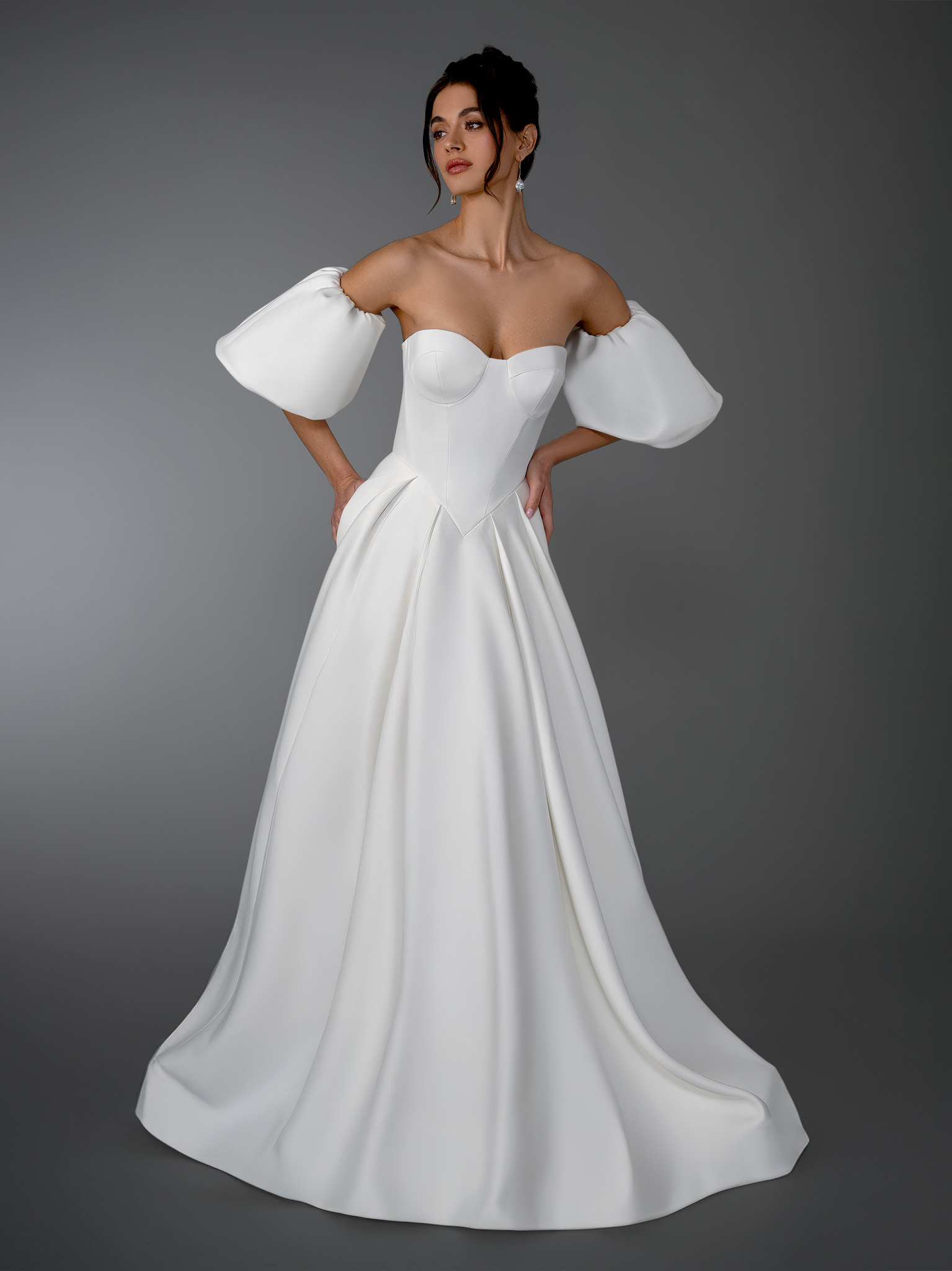 This strapless corset A-line wedding dress is a striking blend of modern structure and romantic drama. Featuring a sculp