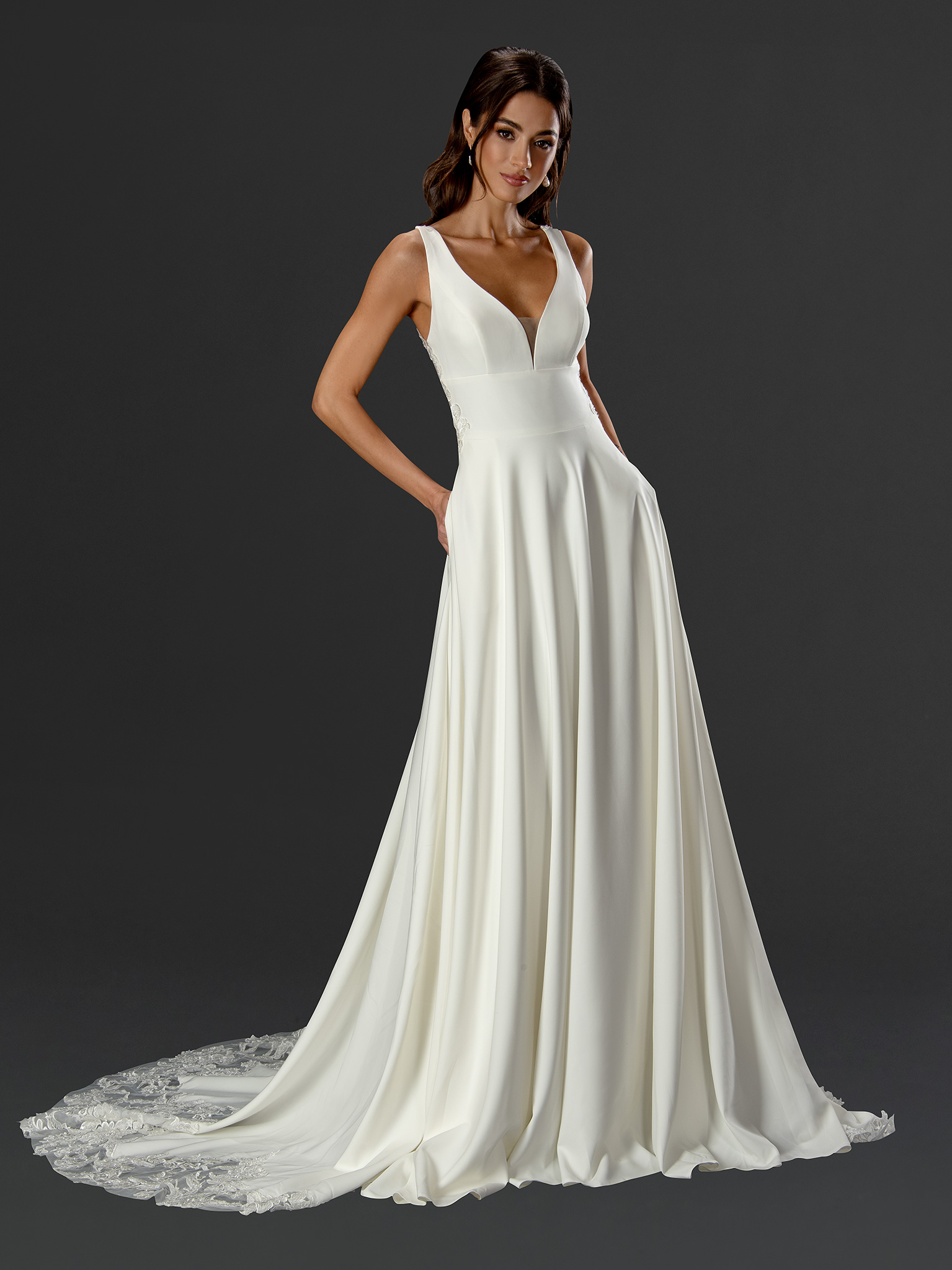 This minimalist A-line wedding dress blends clean, modern lines with subtle romantic details. The sleek fitted bodice an