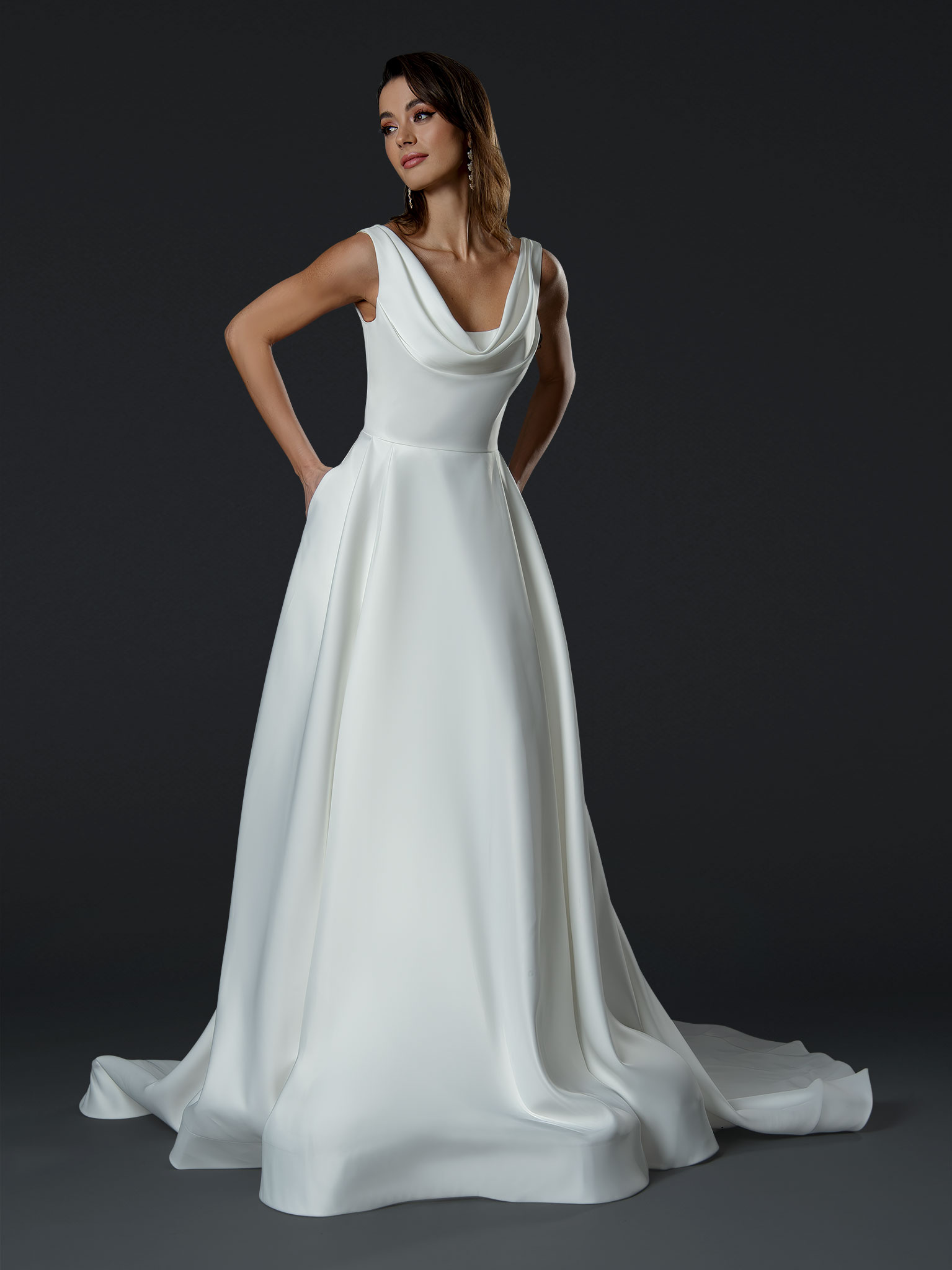 This modern cowl neck A-line wedding dress is the perfect blend of simplicity and elegance. Featuring a softly draped co